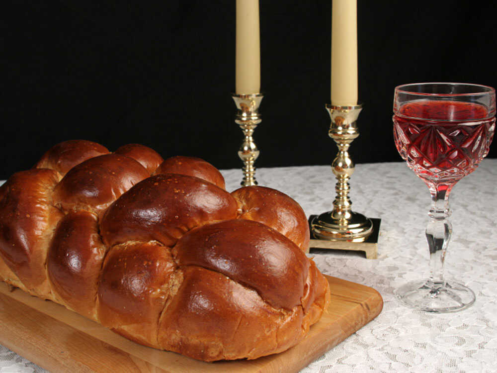 Shabbat candles, challah, and wine image